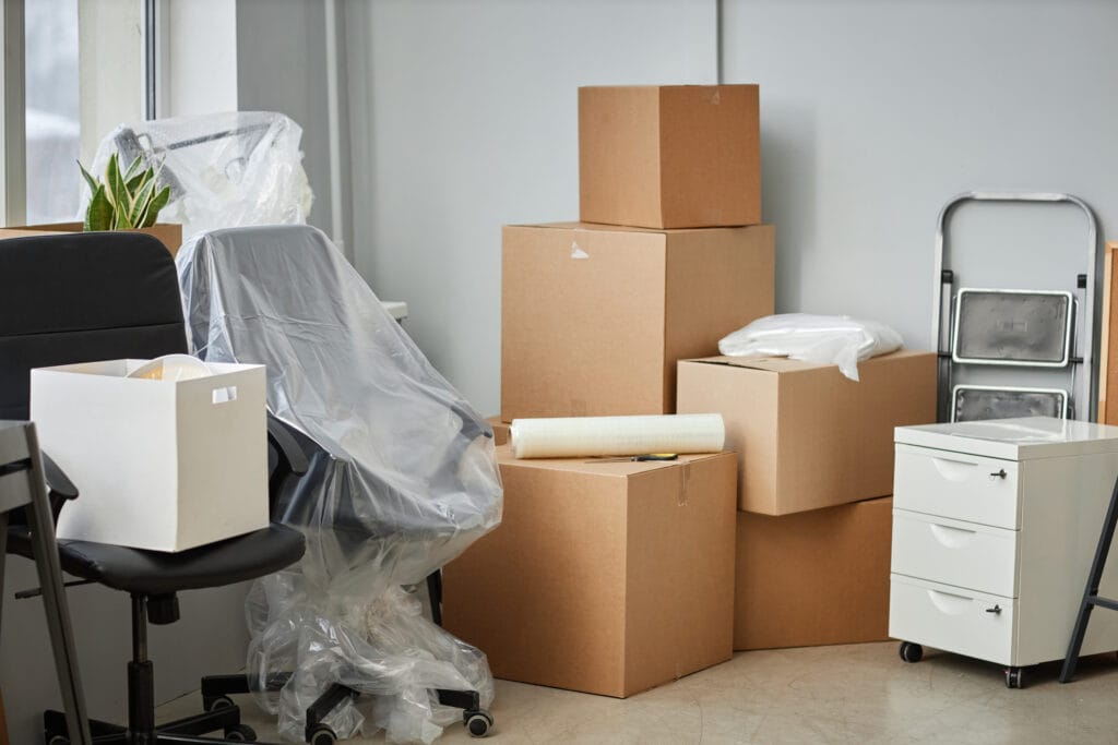 movers in sharjah - Relocation to a new office with boxes and furniture